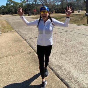 Blog - Jamie Smiling With Her Hands Up After Running a Marothon Outside